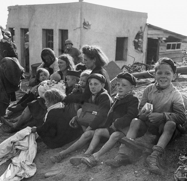 #1 French civilian refugees sought refuge in a beachhead area in Normandy, 1944.