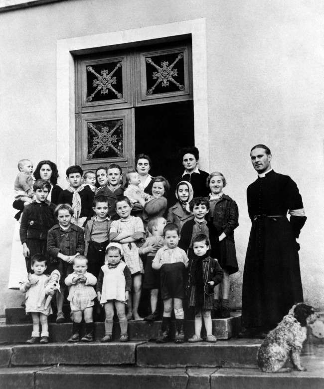 #24 French war orphans with Abbe Noe, Parish priest, at the new French colony opened by the Foster Parents plan for war children, 1944.