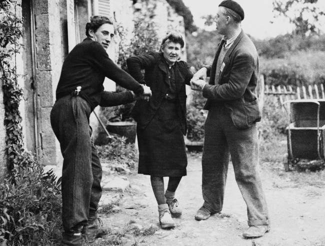 #4 Two French patriots dragged Grande Guillotte from her home in Normandy, France, 1944.