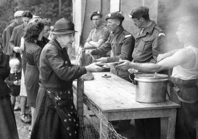 #43 Although freedom has now been restored to parts of Normandy there remain many problems which the Allies are in process of solving. The most urgent is the housing of thousands of refugees, many of whom have fled through the German lines, to gain their freedom behind the Allied lines. Families have been split up and the task of re-uniting them is very difficult. British troops serving food to the refugees in the liberated town of Bayeux and the surrounding area in France, 1944.