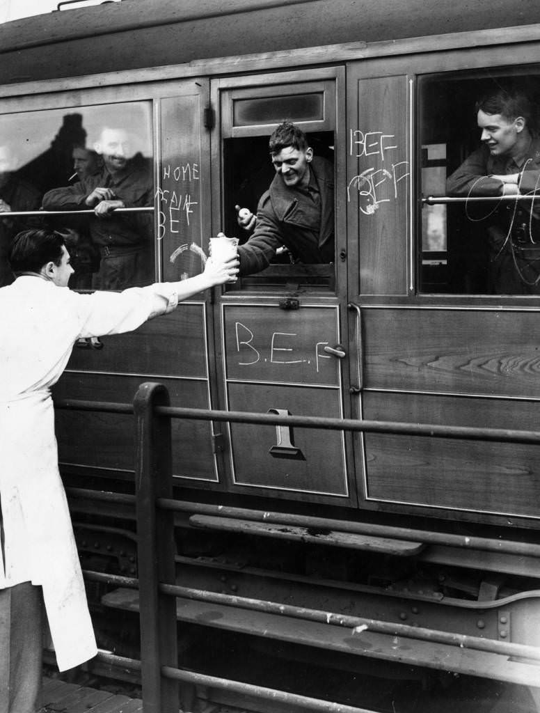 #13 Voluntary helpers give refreshments to wounded soldiers, members of the British Expeditionary Force, on board a hospital train, 1940.