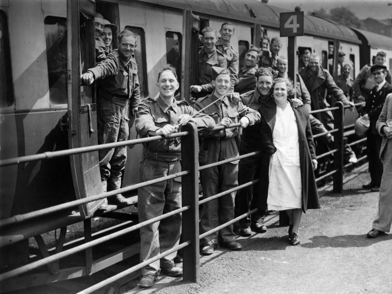 #15 Members of the BEF (British Expeditionary Force) smiling happily at a halt in their journey as they arrive safely in England after escape from Dunkirk, 1940.