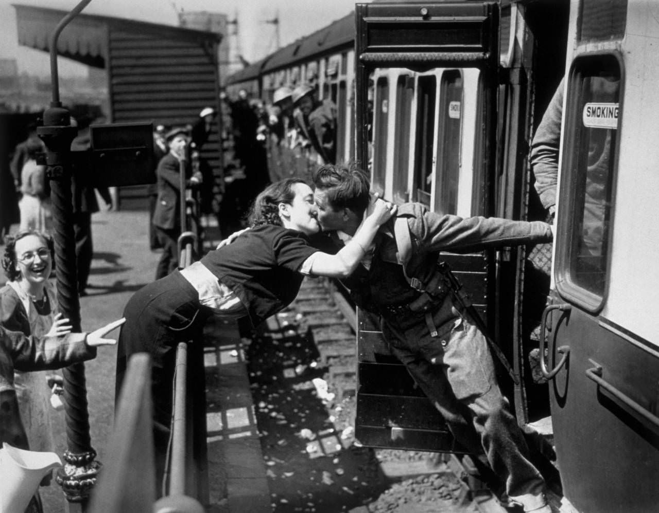 #16 A soldier of the British Expeditionary Force, arriving back from Dunkirk, is greeted affectionately by his girlfriend, 1940.