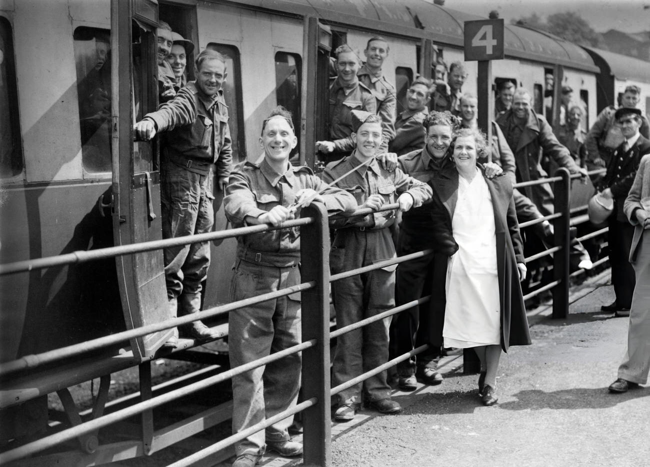 #31 Members of the BEF (British Expeditionary Force) smiling happily at a halt in their journey as they arrive safely in England after escape from Dunkirk, 1940.