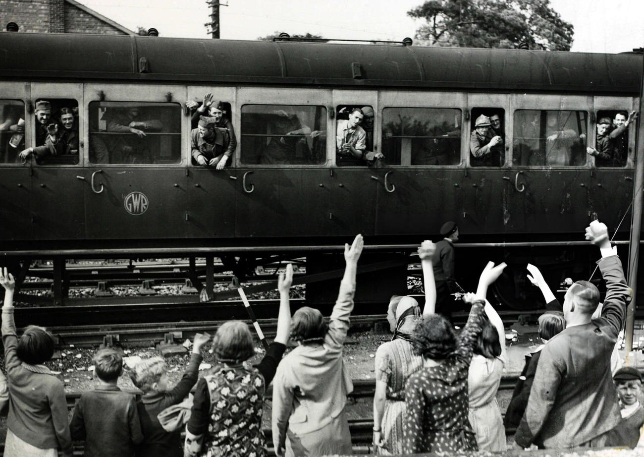 #33 Men of the French Army greeted by villagers at a Kent railway station after their evacuation from France during the Battle of Dunkirk, 1940s.