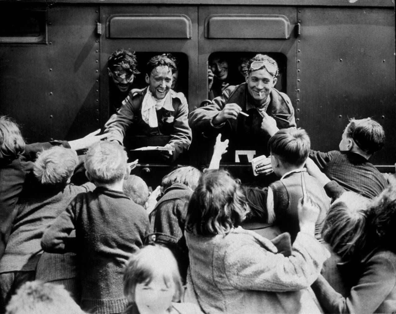 #8 Children rush up to a train carrying BEF men back from Dunkirk, 1940.