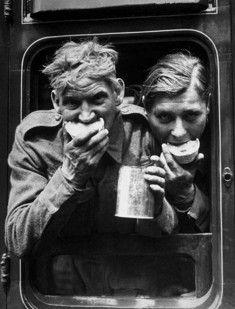 #9 Two soldiers tuck in to the food and refreshment they received after their arrival in Britain, after evacuation from Dunkirk, 1940.
