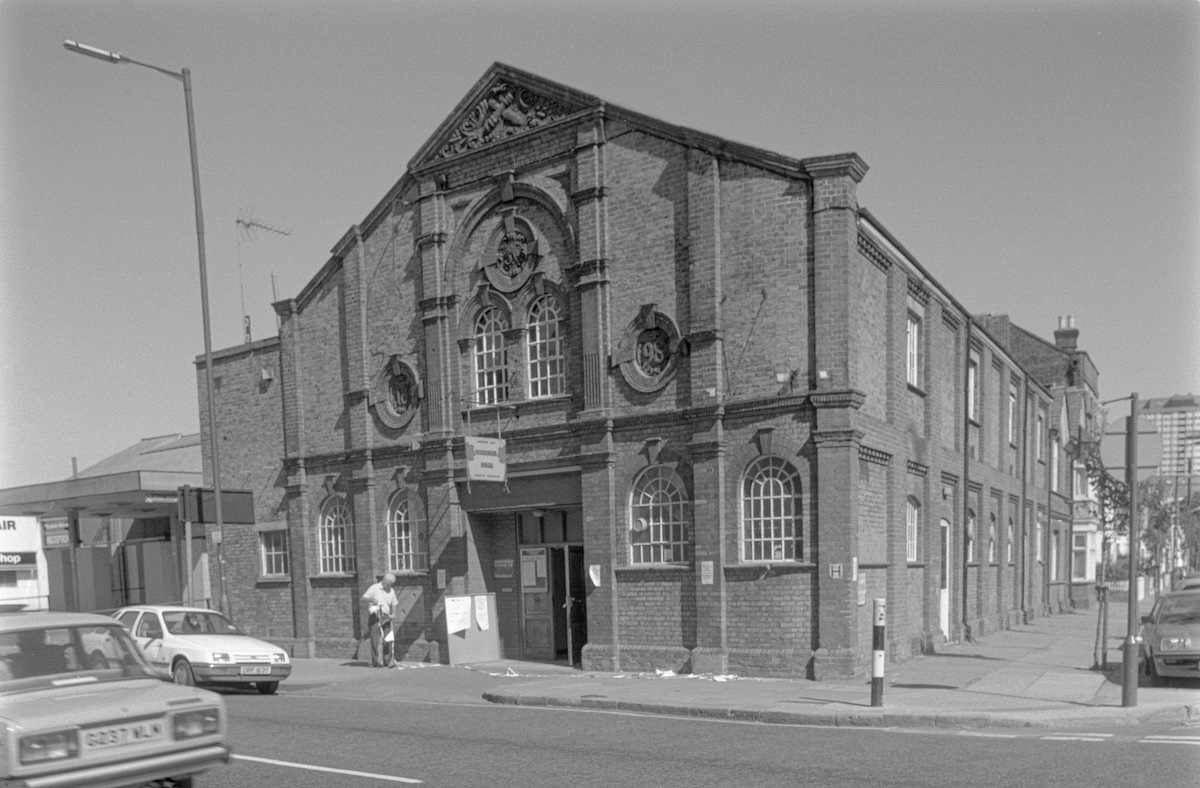 #13 Shepherds Bush Village Hall, 1990.Built in 1898 as the drill hall for the 1st City of London Volunteer Artillery, it became a hall owned by the London Borough of Hammersmith and Fulham until sold to the Wigoder Family Foundation in 2012.