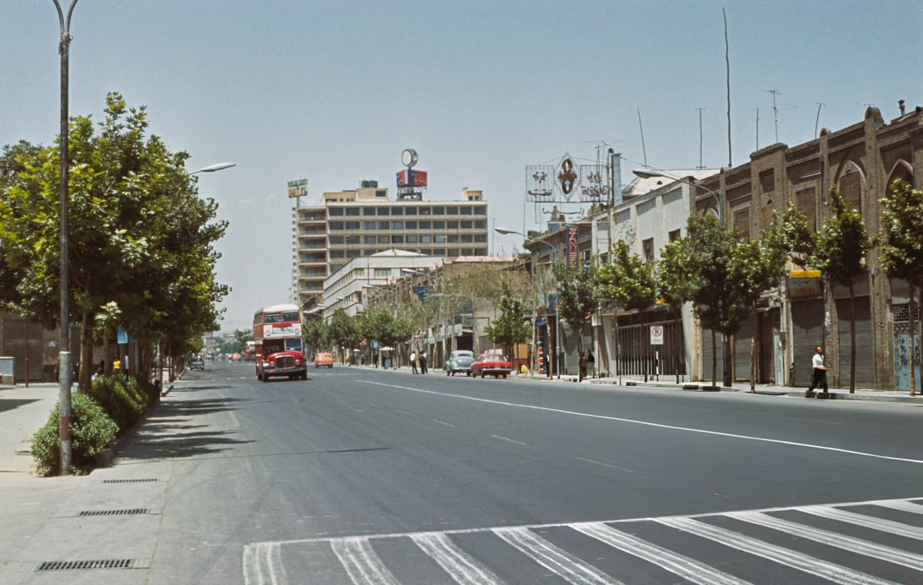 #12 Double-decker buses and cars drive along Ferdausi Street in Tehran, 1967.