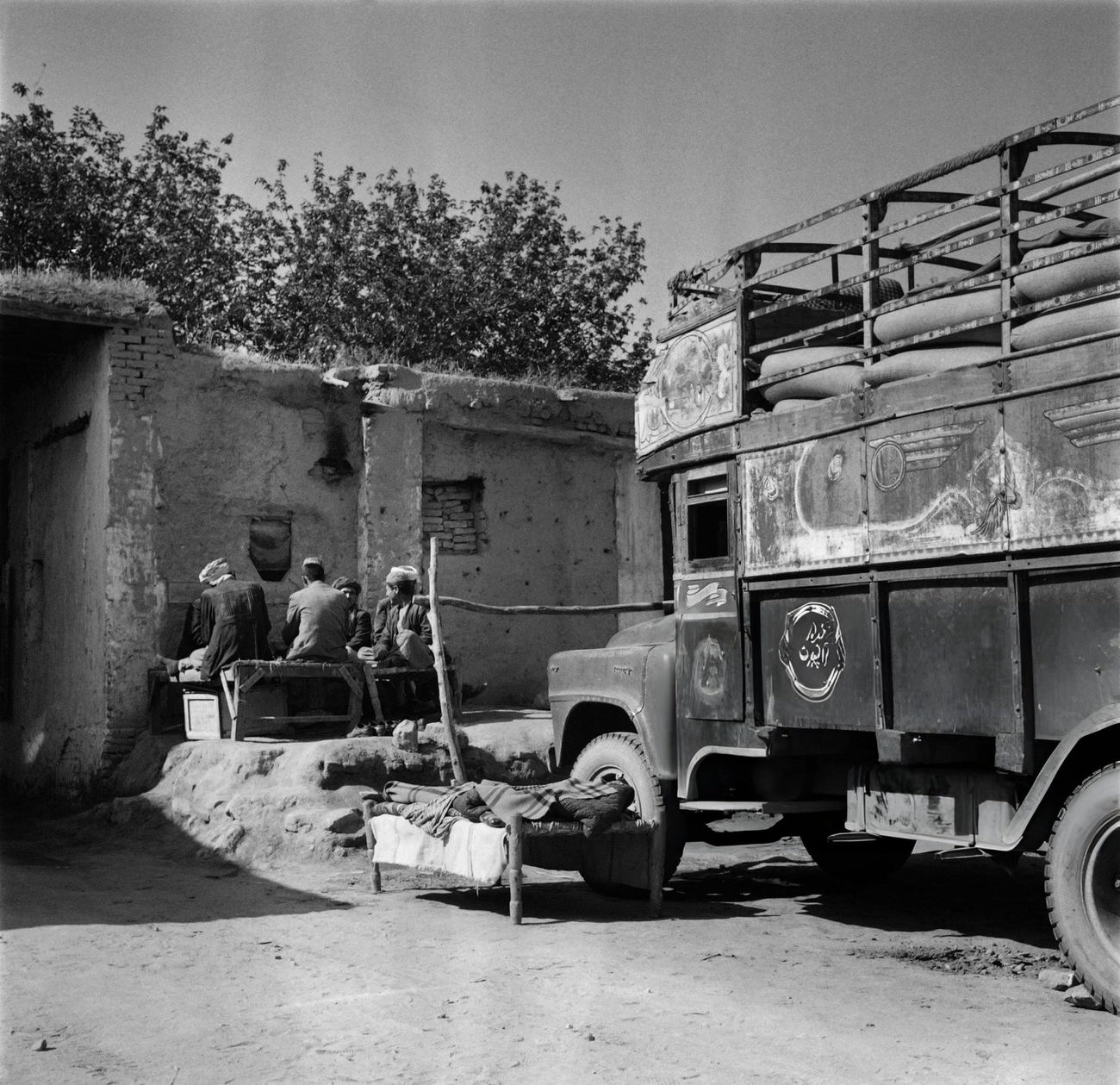 #48 Iranian men rest in a street of Tehran, 1968.