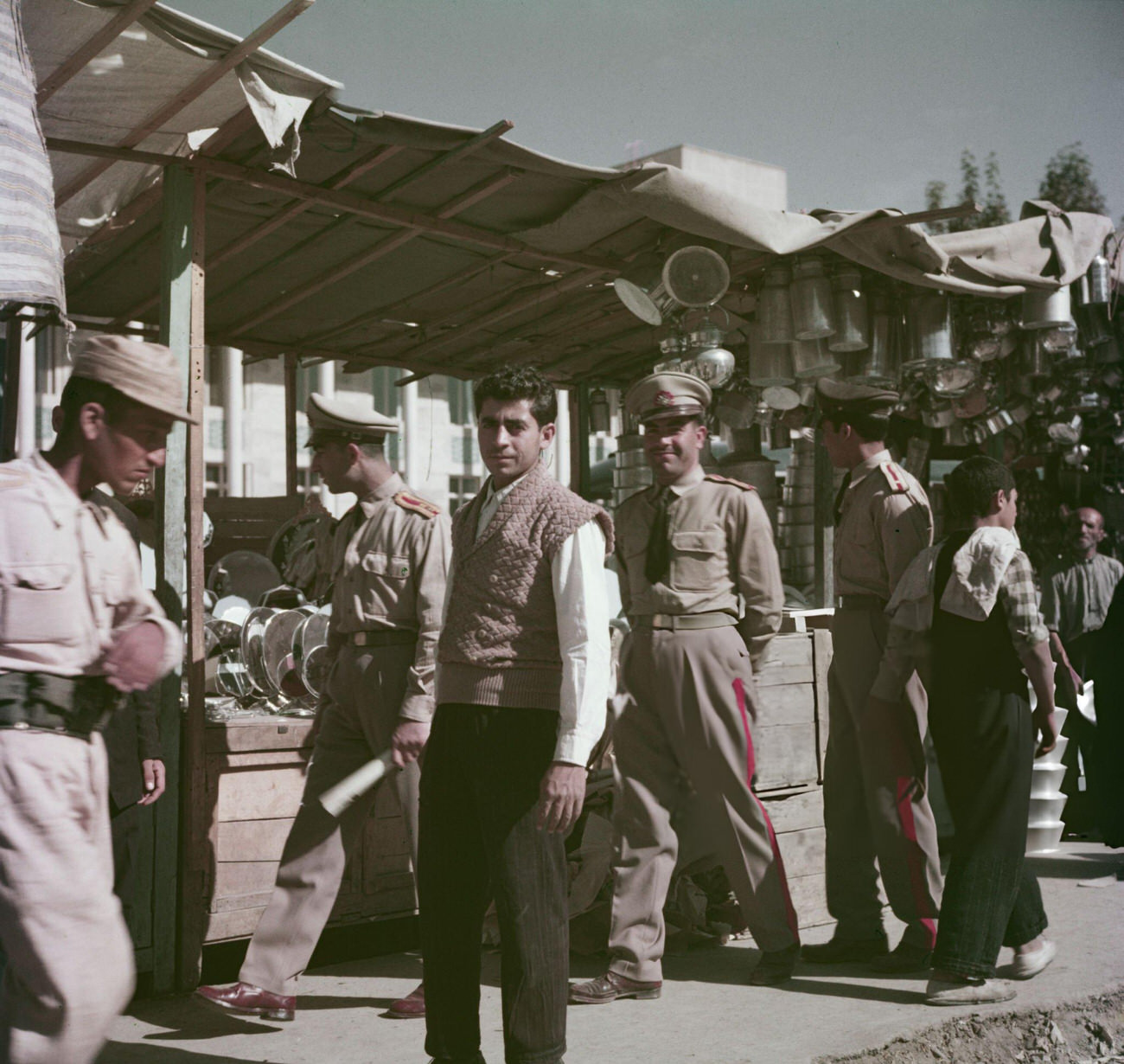 #24 Soldiers from the Imperial Iranian Armed Forces join other customers at a street bazaar in Tehran, 1960s.