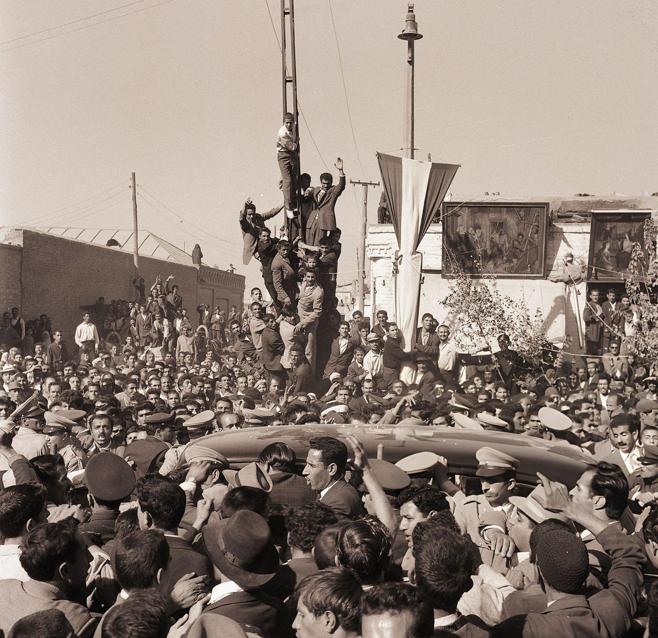 #25 Crowds celebrate the birth of a son to the Shah of Iran, 1960.