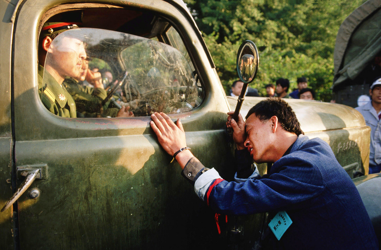 #9 A weary protester pleads with a People’s Liberation Army (PLA) officer sitting in his truck to not crack down on the student demonstrators.