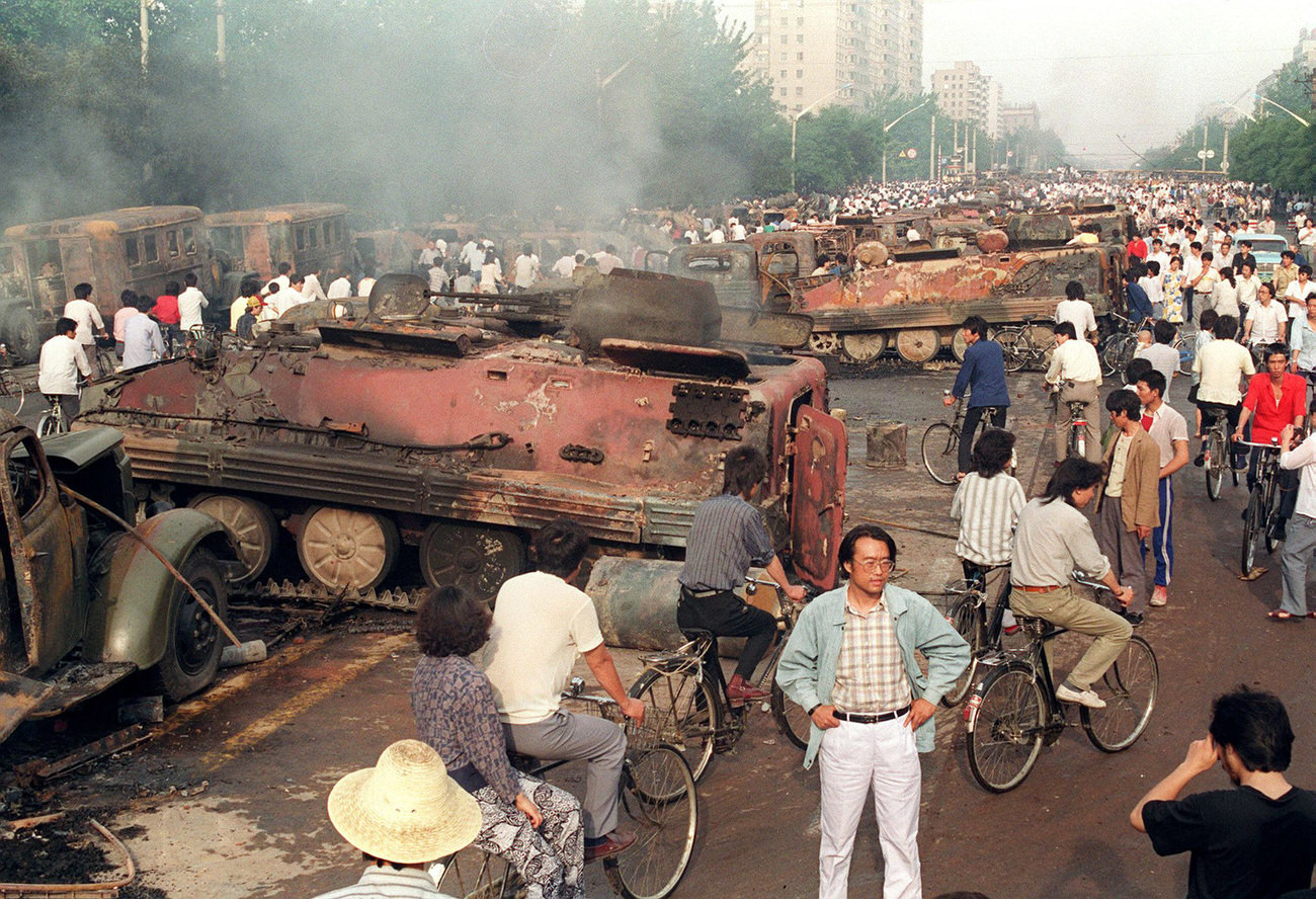 #23 Beijing residents inspect the interior of some of more than 20 armored personnel carriers burned by demonstrators to prevent the troops from moving into Tiananmen Square.