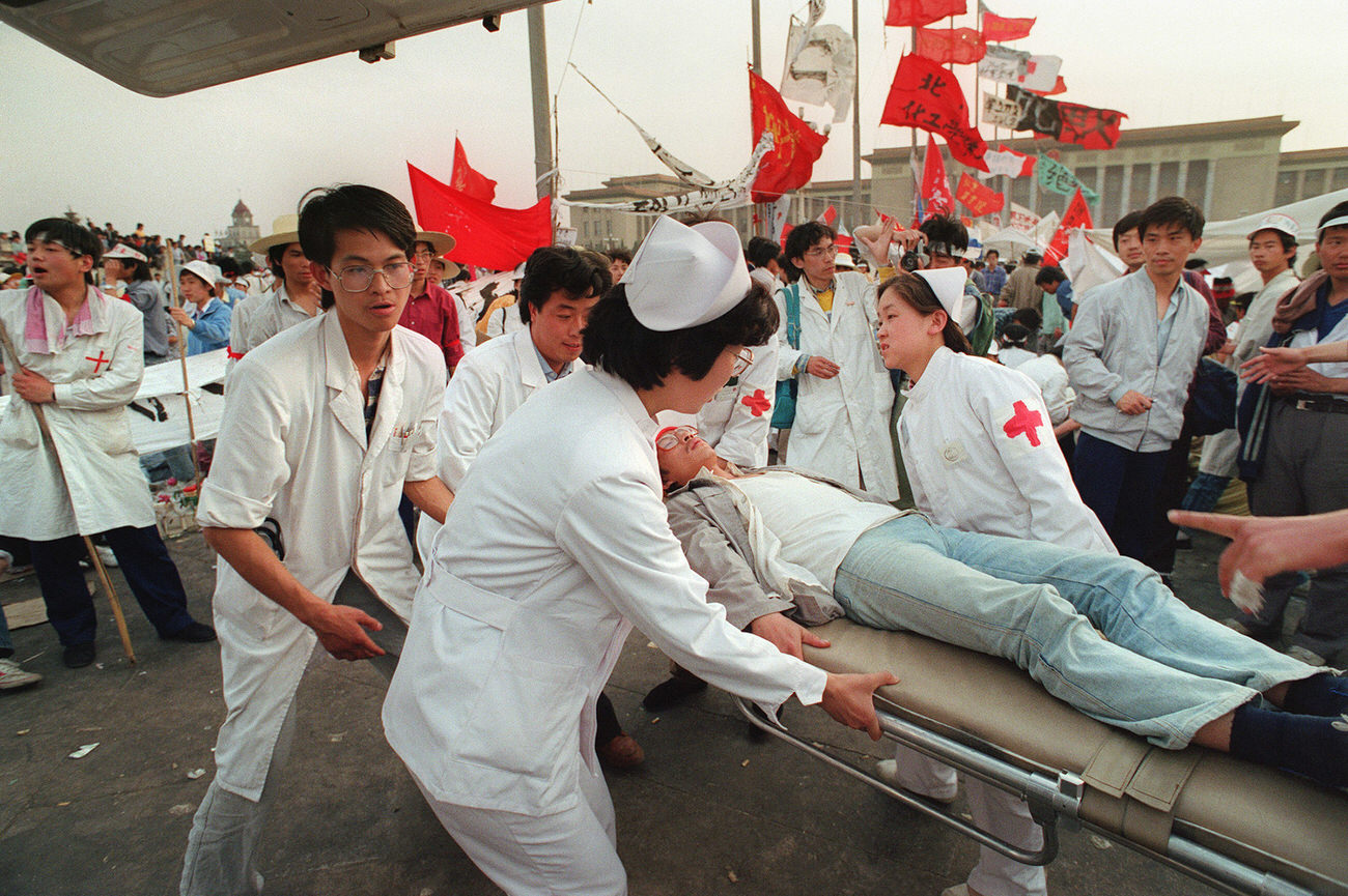 #7 Paramedics evacuate an ailing hunger striker from Beijing University at Tiananmen Square, as students enter the fifth day of hunger strikes.