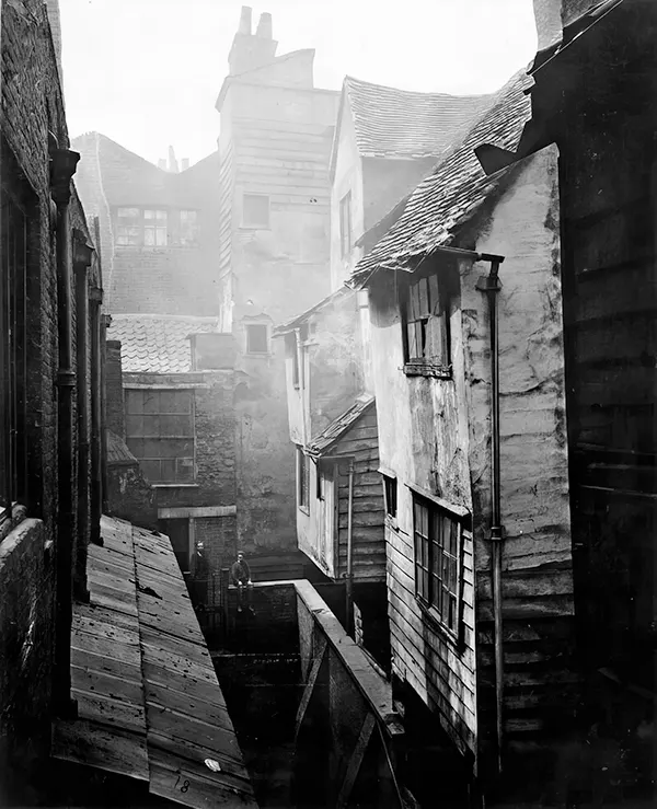 #15 While some of London’s slums were hastily erected shantytowns, other slums were made of centuries-old houses. This photograph from 1877 shows homes in Cloth Fair built after the Great Fire of London in the 17th century.