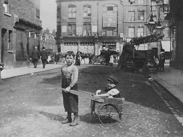 #23 Two Jewish children play on an East End street. 1900s.