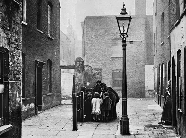 #25 A slum street in an area marked for demolition. 1901.
