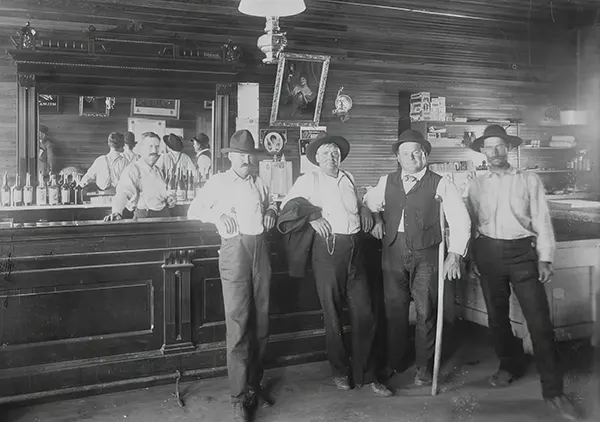 #20 Men pose in a Wild West saloon.