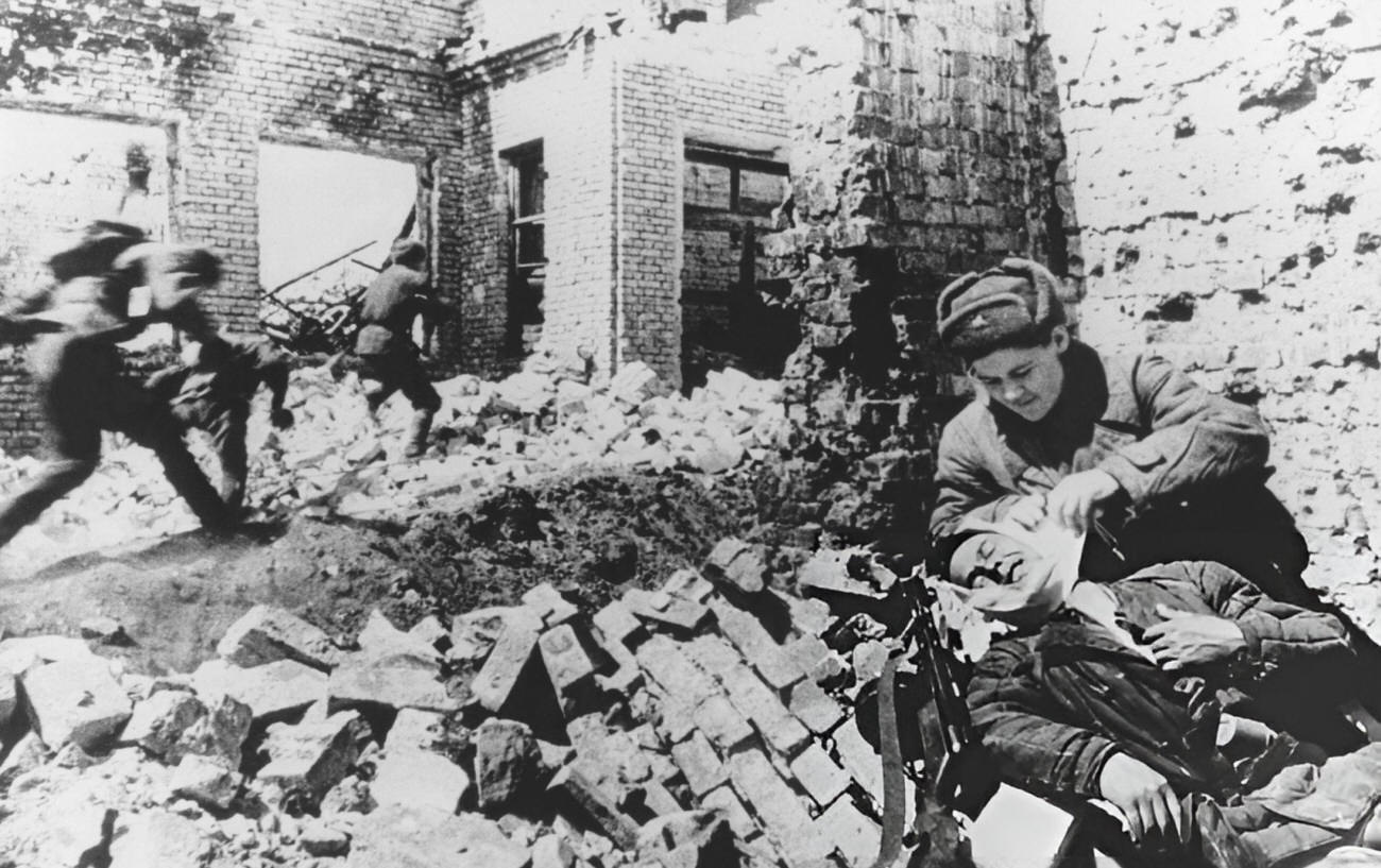 #34 Soviet Soldiers Leaping As A Military Male Nurse Treats A Wounded Soldier, 1942.