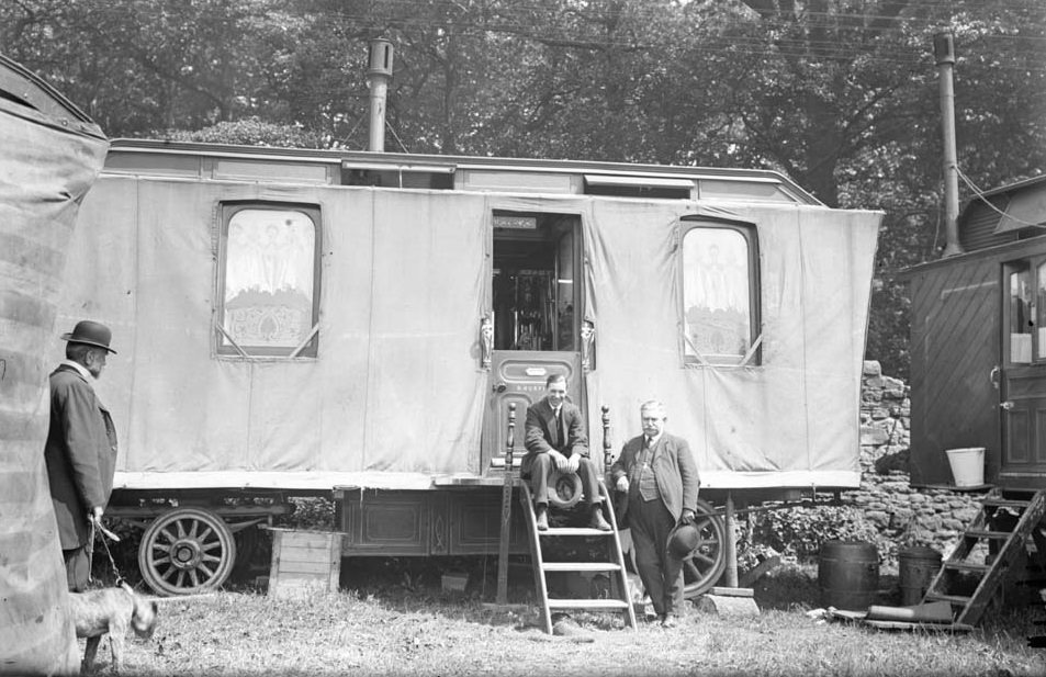 #6 A.J.Fenwick sat on the steps of a showman’s caravan