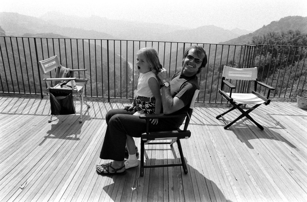 #14 Jack Nicholson plays with his daughter, Jennifer, on the deck of his home overlooking Franklin Canyon, Los Angeles, 1969.