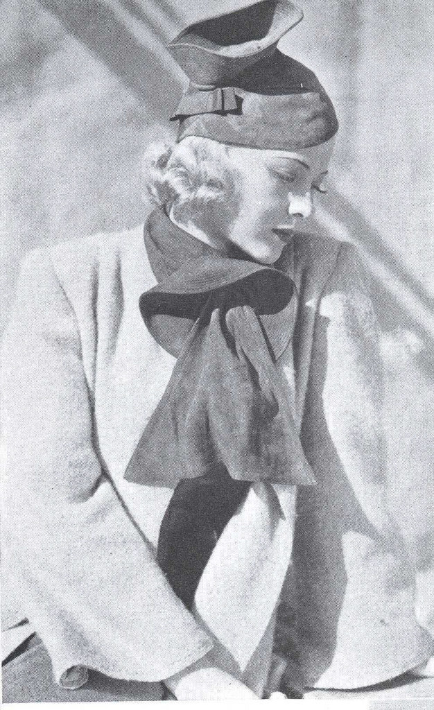 #12 Mary Carlisle in a hat and scarf of rust suède, 1937