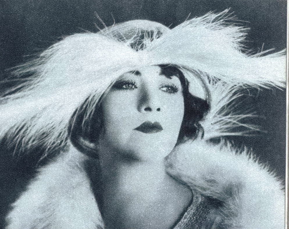 #10 Betty Compson makes a statement in feathers, 1925