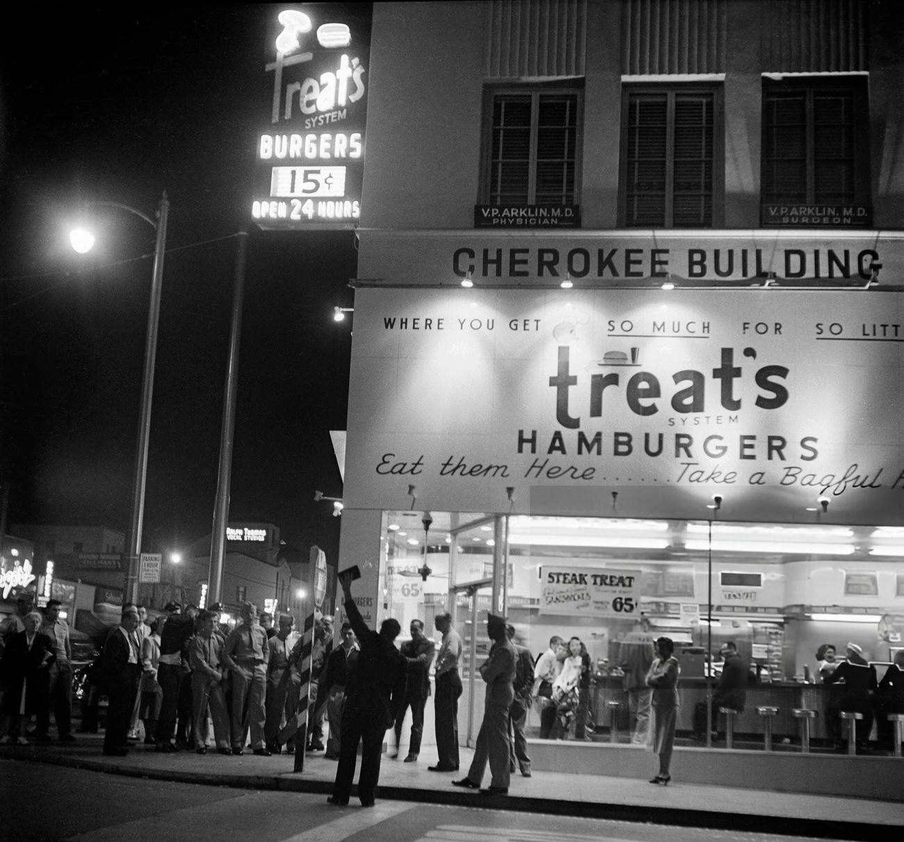 #25 People gathered around Treats Hamburgers on Hollywood Boulevard in Hollywood, California, 1951.