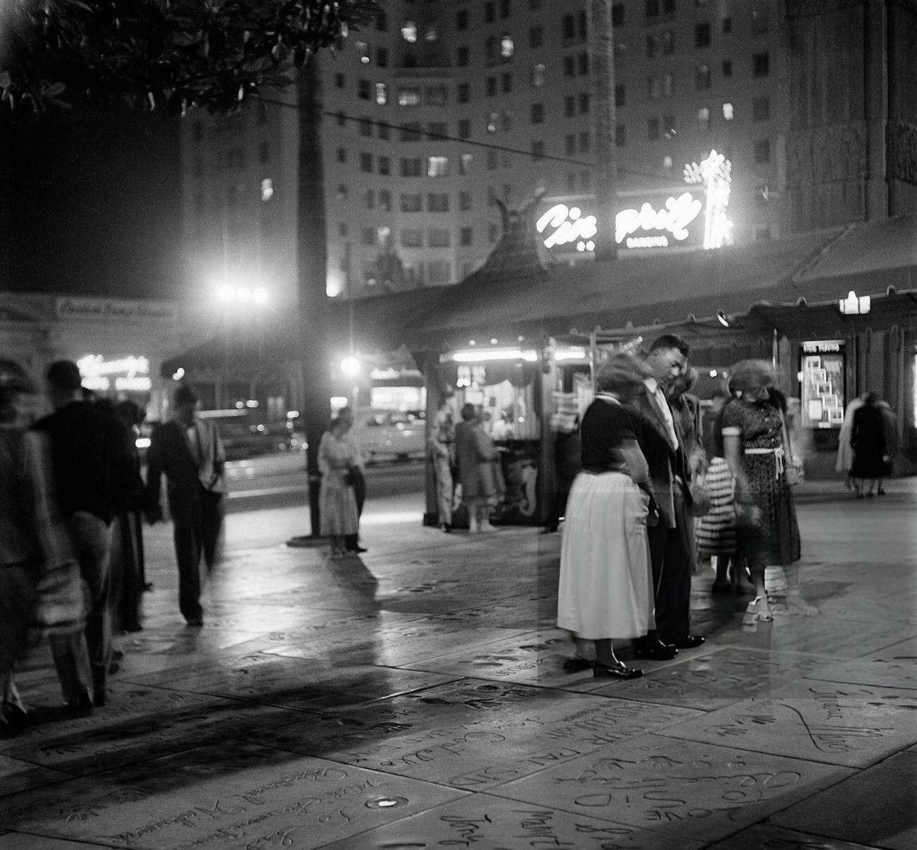 #32 Tourists visiting the footprints at Mann’s Chinese Theatre on Hollywood Boulevard in Hollywood, California, 1951.