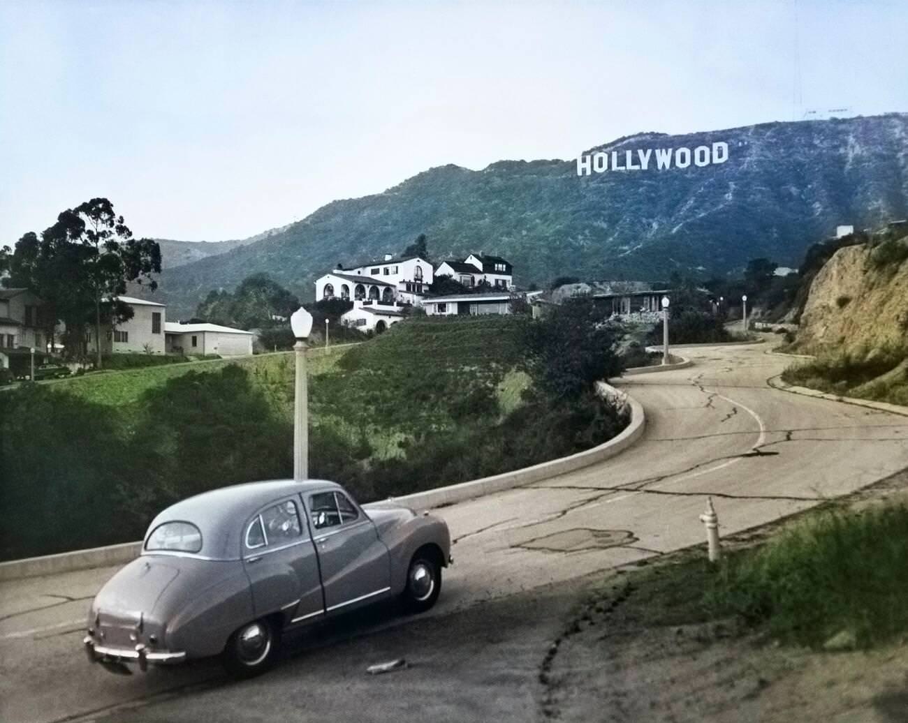 #1 Austin car driving up a road in the Hollywood Hills, 1950s.