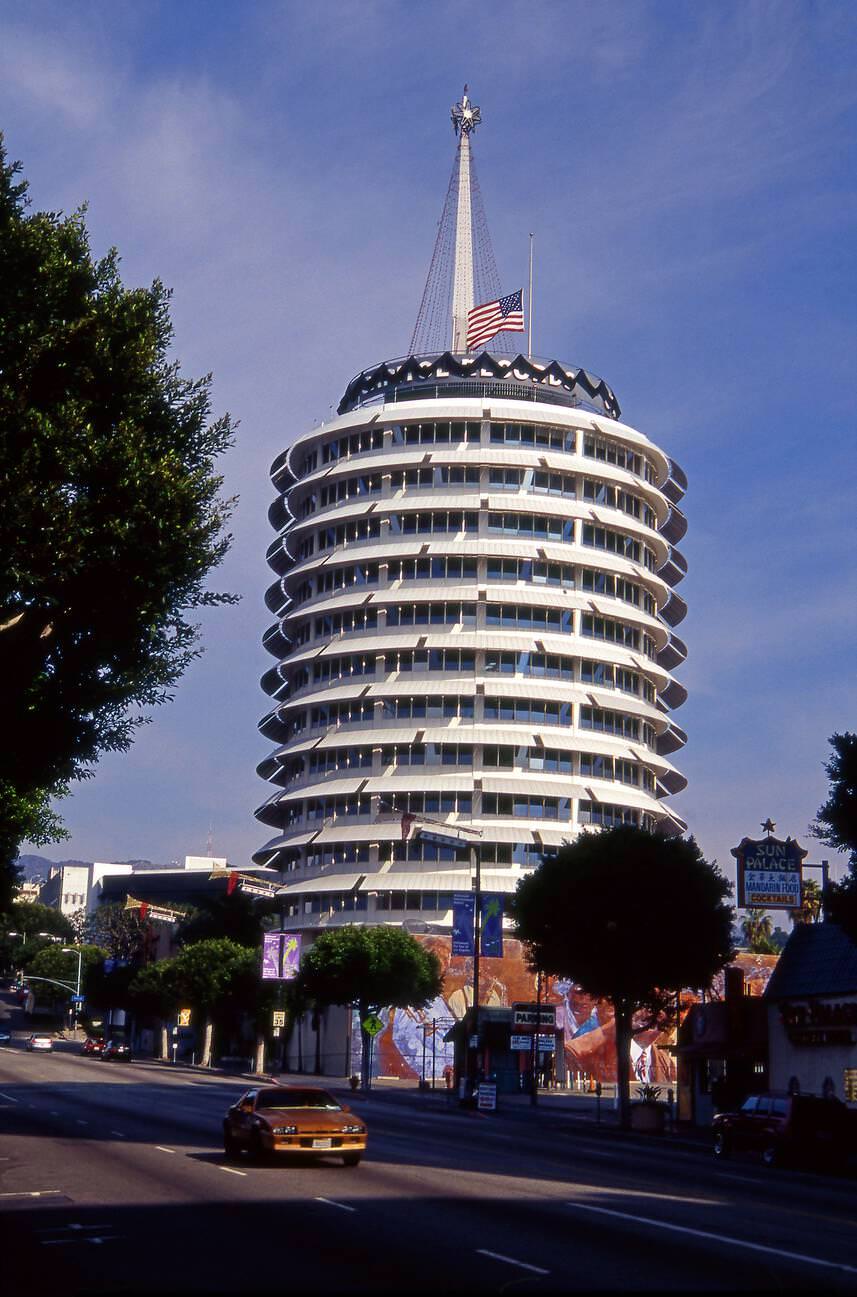 #22 The Capitol Records building with a black band and flag at half-staff to commemorate the death of Beatle great George Harrison, in Hollywood, California, 1960s.