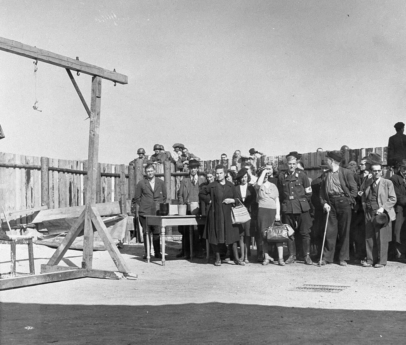 #10 A Red Cross delegation touring Buchenwald concentration camp after its liberation. , 1945.
