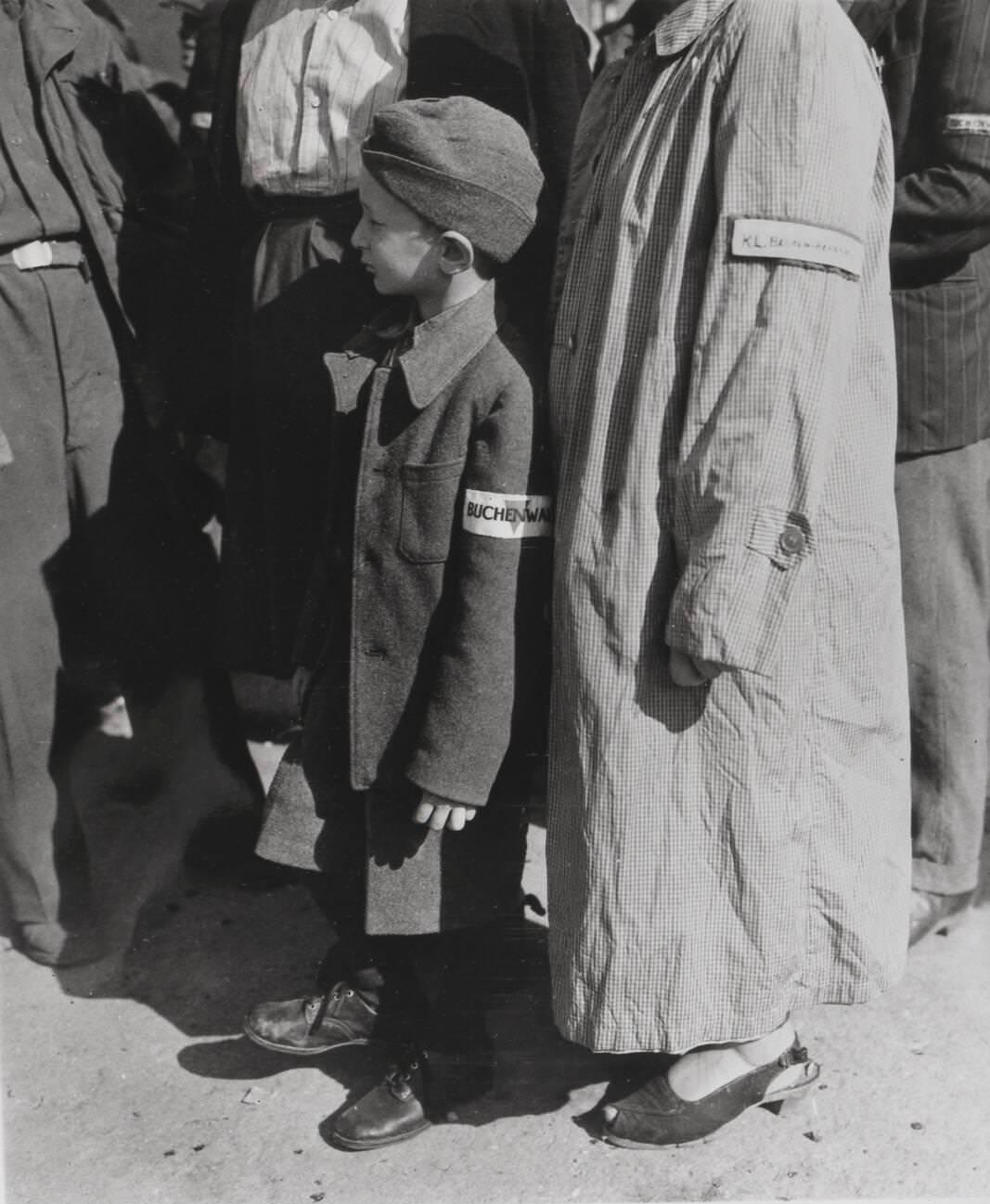 #21 A 7 year old survivor of the Buchenwald concentration camp complex waiting to be processed after liberation of the camp, 1945.