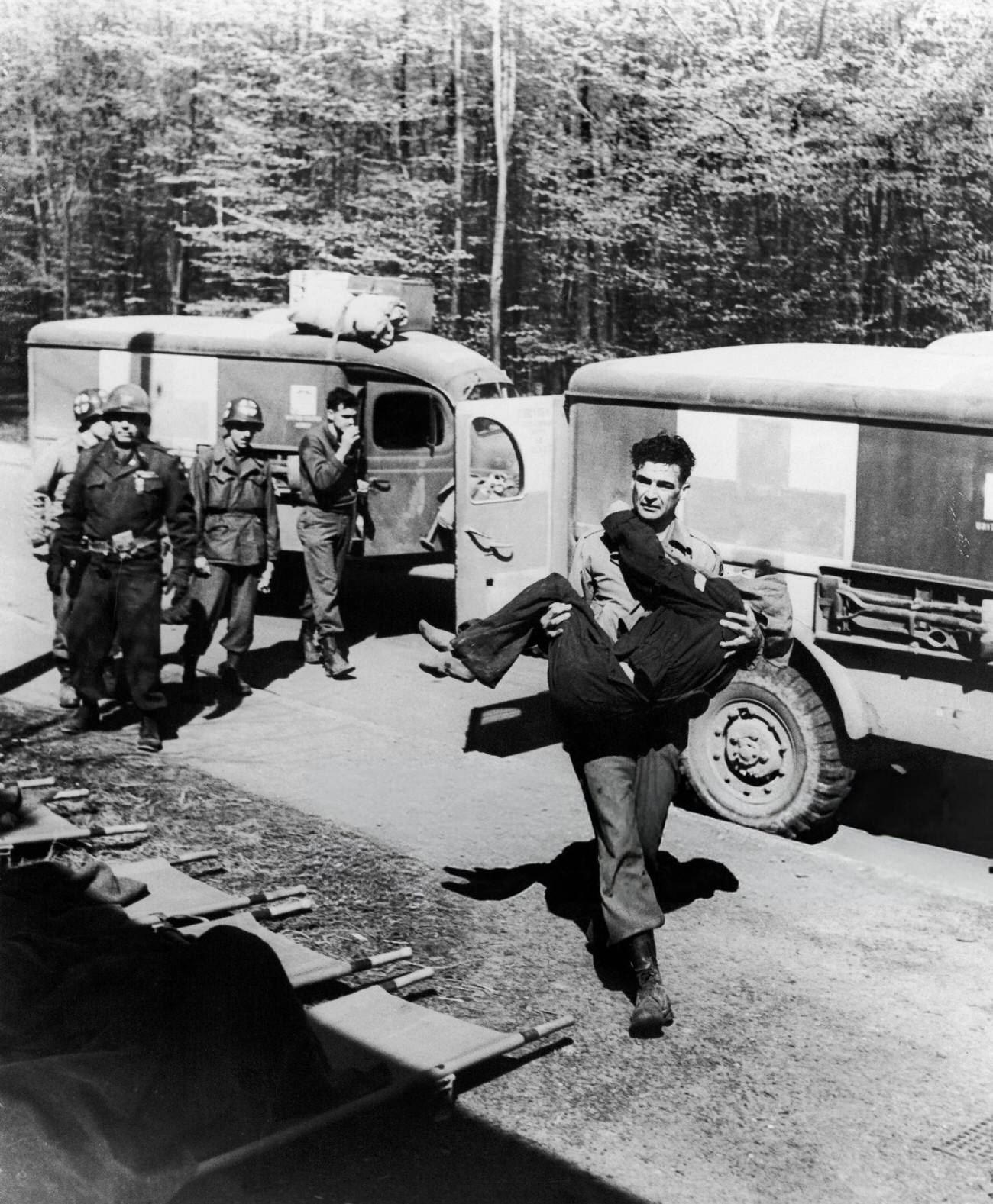 #25 An American Soldier of the 6th Armoured Division Carrying a Hungarian Woman from the Ambulance to the Hospital, After the Liberation of the Camp of Penig-Langenleuba, Close To Altenbourg, Germany, 1945.
