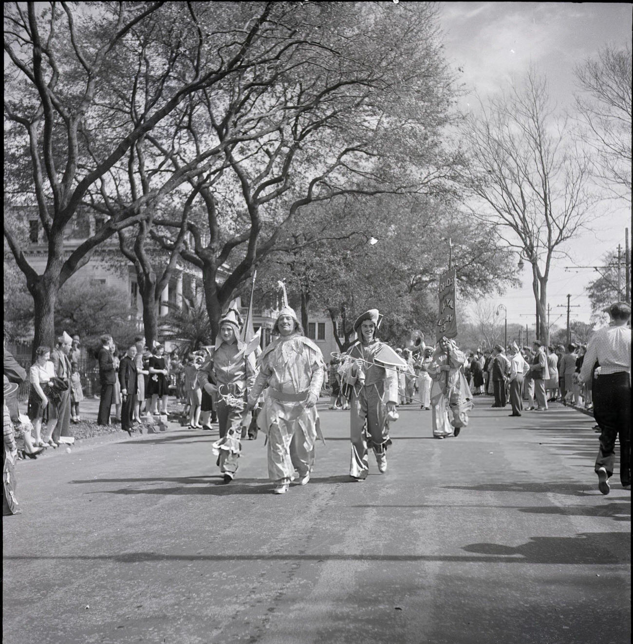 #47 Spectators Line a Street to Watch a Mardi Gras Club Hold Their Costume Parade, 1950s.