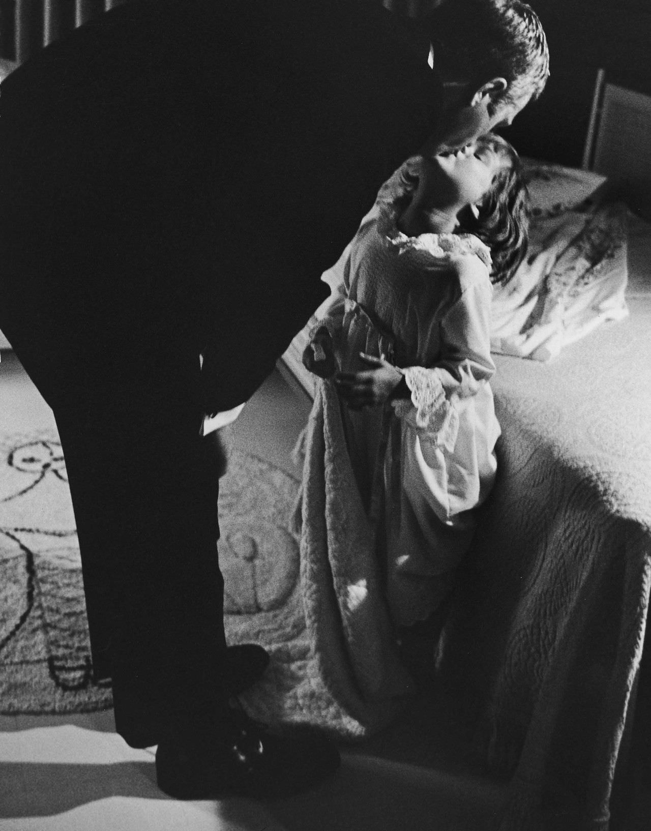 #12 Steve McQueen kissing his daughter, Terry, goodnight, 1963.