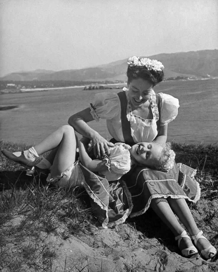 #3 Joan Crawford with her daughter in Monterey, California, 1945.