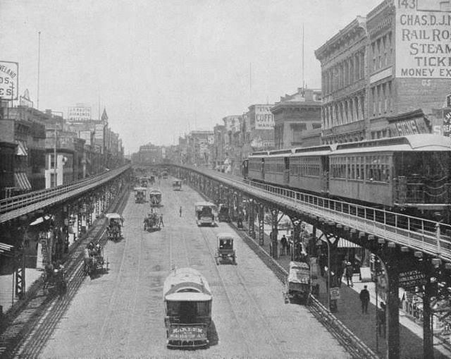 #2 3rd Ave line of the Manhattan Elevated Railway running on tracks constructed alongside the Bowery which is being utilized by both horse drawn and mechanical traffic