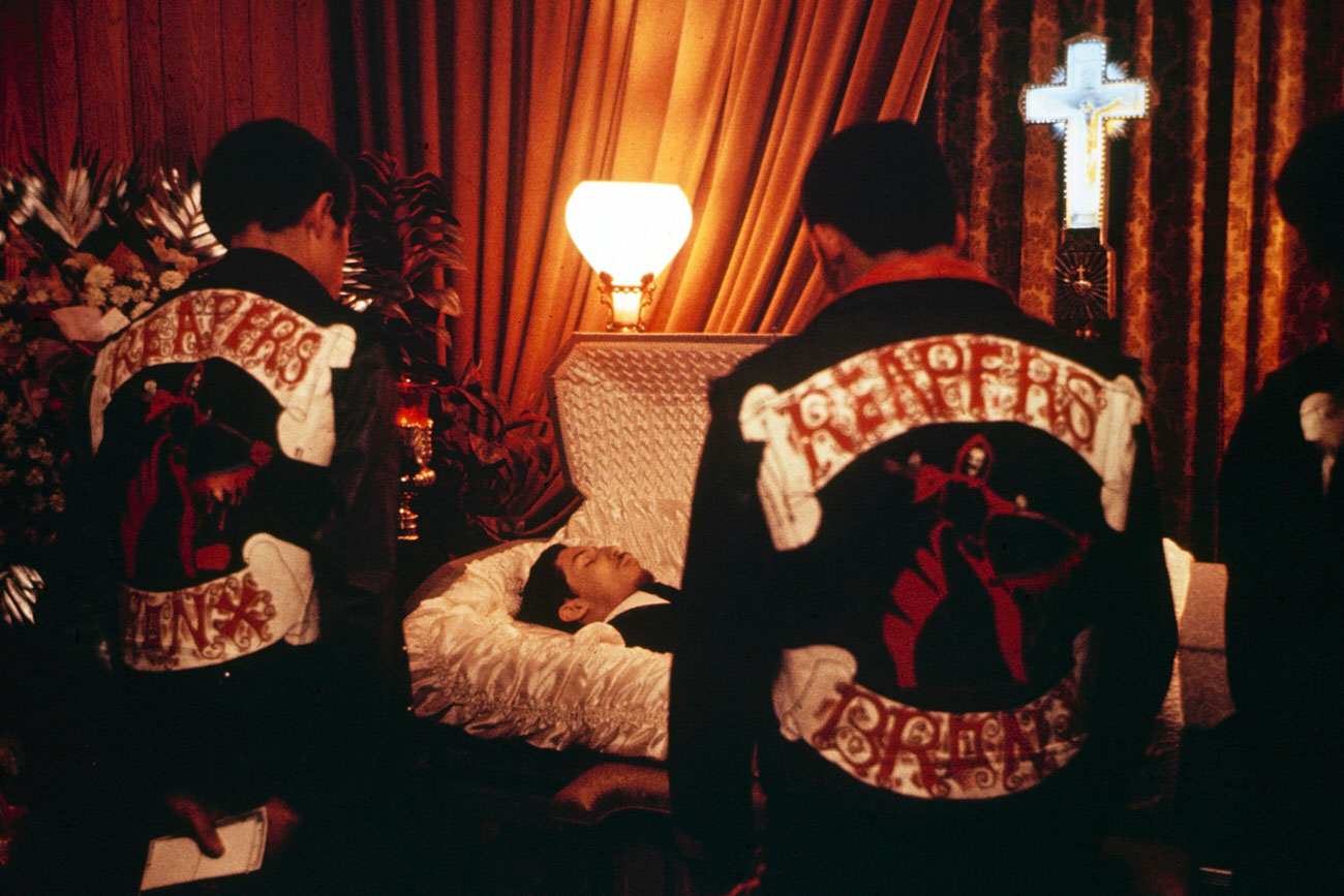 #8 Eddie and his fellow Reapers pay their respects to ‘Chino’ Rosa, a member of a neighboring gang who was knifed to death. Friends of Chino’s say he was held up and murdered by a junkie, but a grand jury decided that Chino’s assailant had been acting in self-defense. The Reapers donated a week’s dues to the bereaved family.