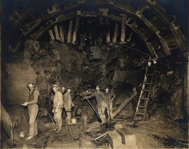#5 Subway tunnel under construction: laborers look at camera.” No date given.