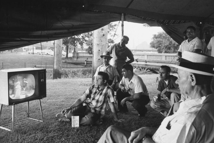 #1 Picketing workers watch TV in a tent outside the gates of a U.S. Steel plant in Gary, Indiana, during a strike in 1959
