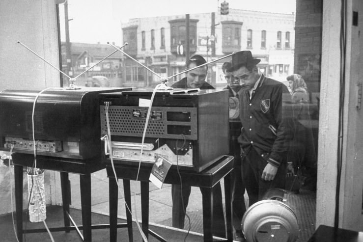 #6 Men gather to watch TV through a store window in Pennsylvania in 1948