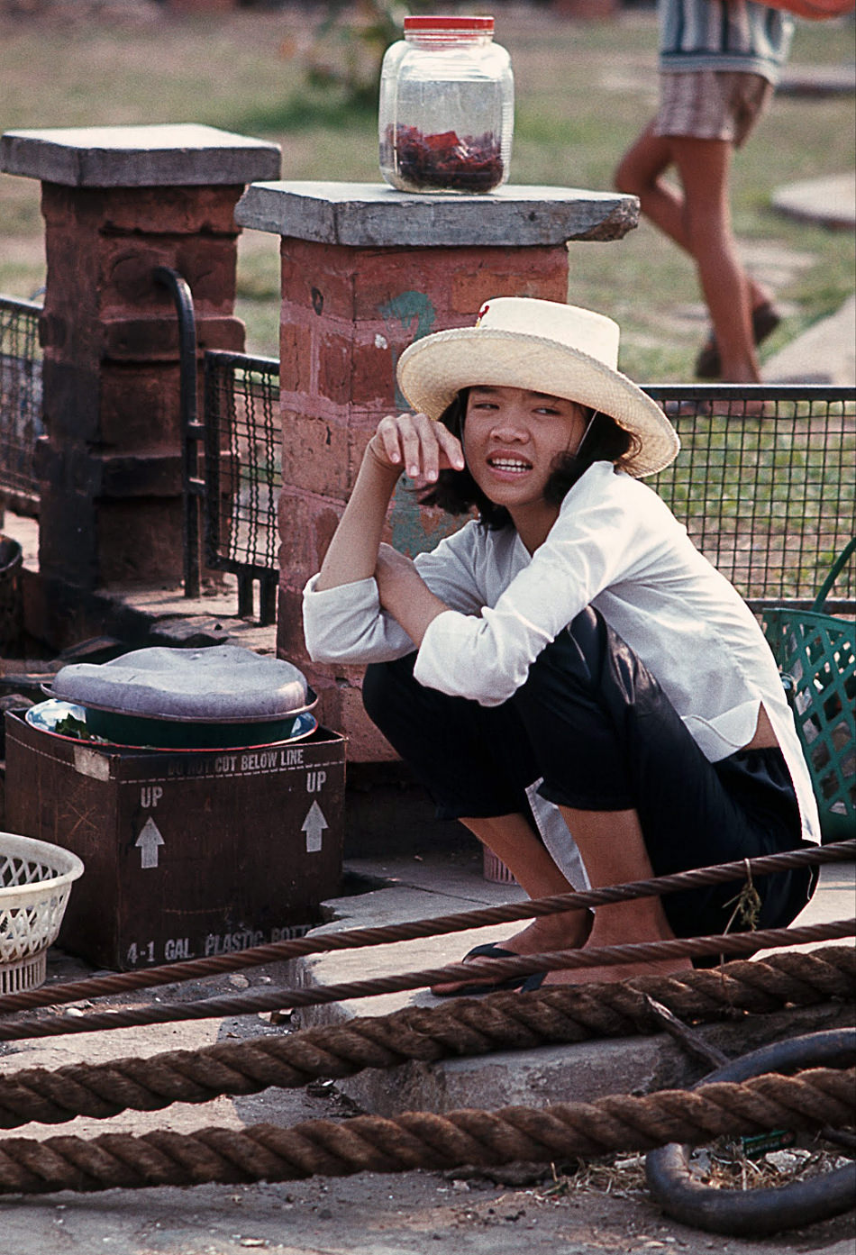 #102 A food vendor at the Saigon docks, 1968.