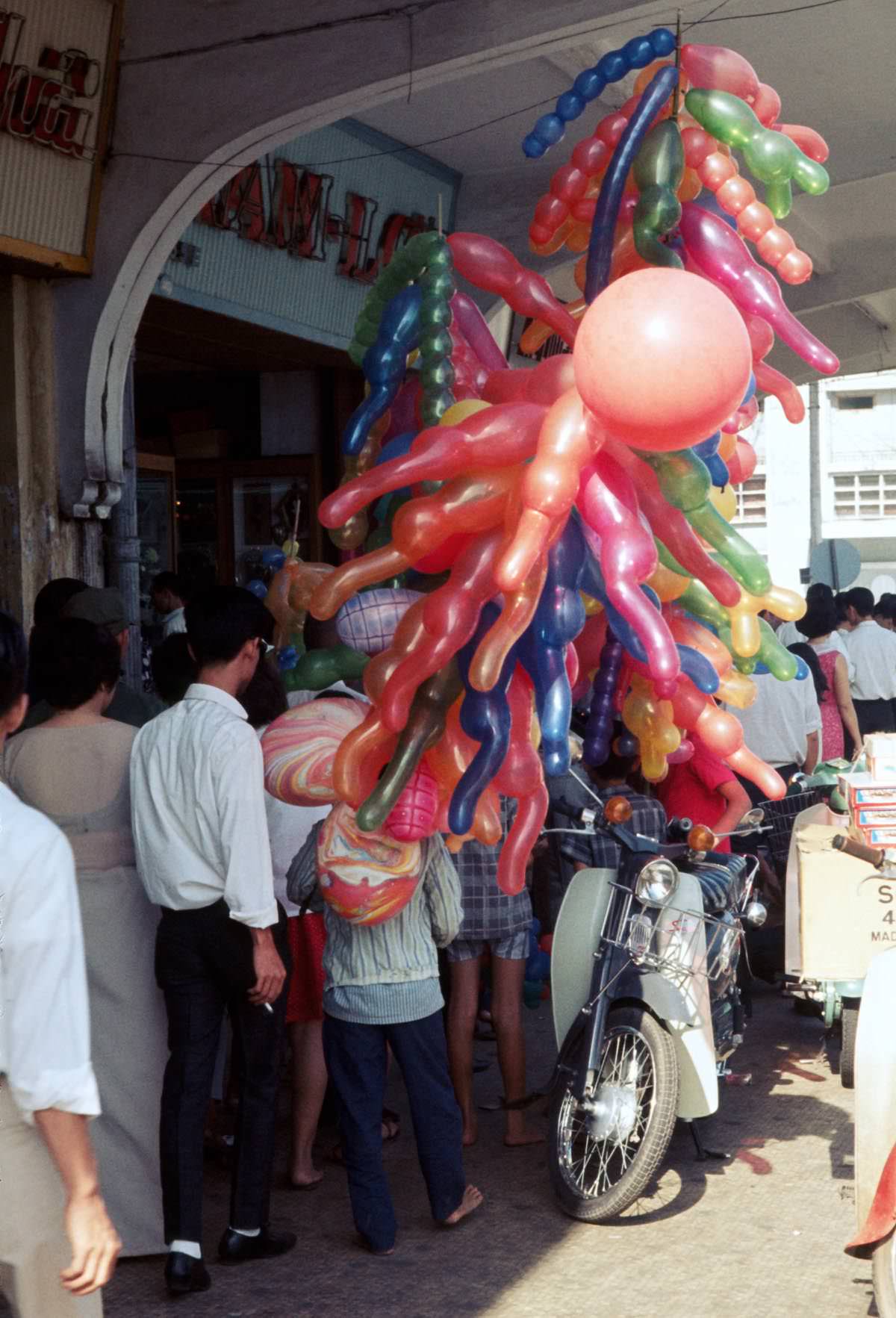 #56 A balloon vendor on Nguyen Hue Street in Saigon, 1968.