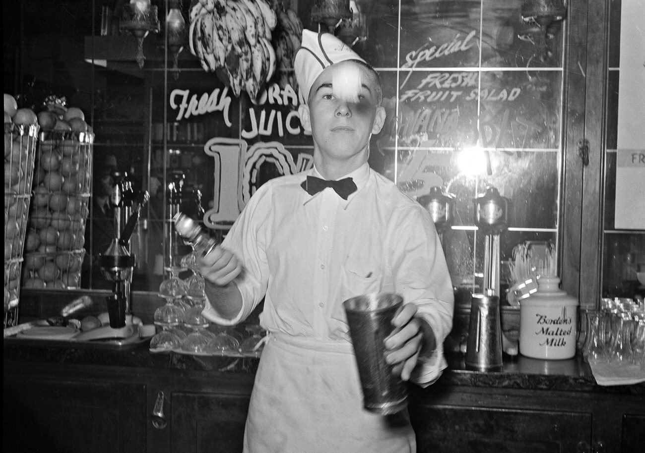 #18 A soda jerk making malted milk shakes in Corpus Christi, Texas, 1939.