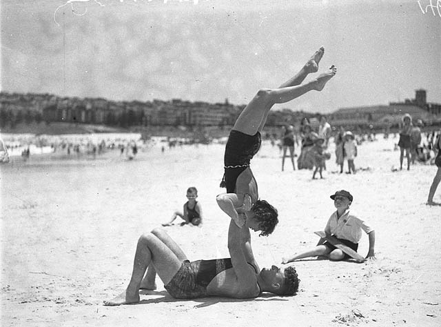 #13 Mr. J. Prentice and Miss J. Howat performing beach acrobatics at Bondi Beach, January 1935.