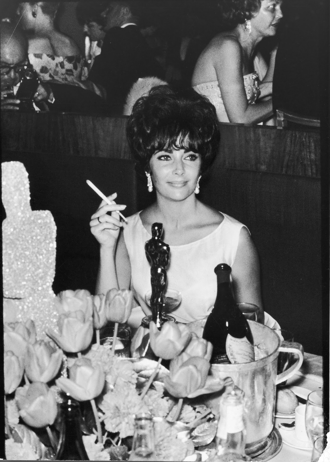 #17 Elizabeth Taylor at a party after winning the Oscar for her performance in BUtterfield 8, 1961.
