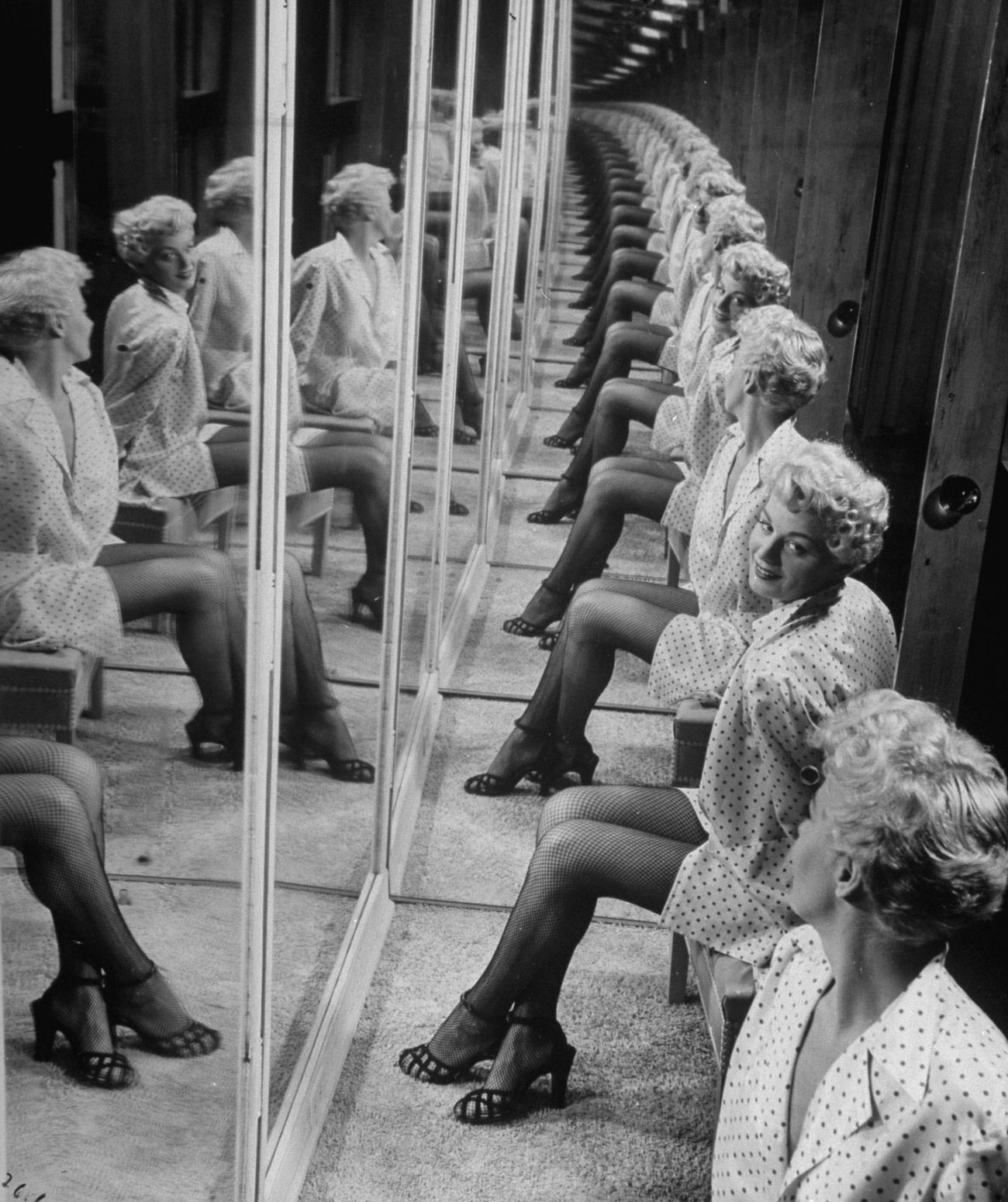 #28 Shelley Winters in a booth with mirrors, 1949.