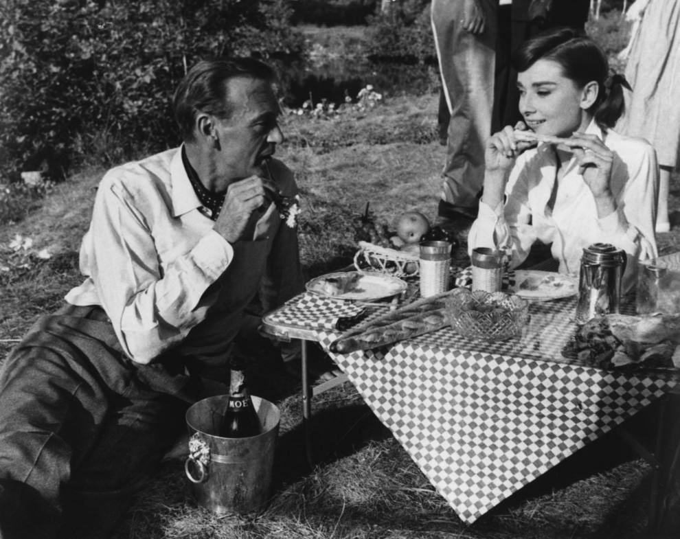 #12 Audrey Hepburn & Gary Cooper sharing a picnic. On the Paris set of the film ‘Love in the Afternoon’, 1956.